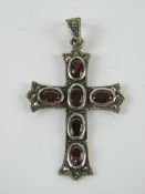 A silver garnet and marcasite cross or crucifix pendant, 5cm in length, stamped 925.