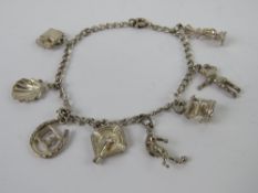 A sterling silver charm bracelet having eight charms upon, 14.5g.