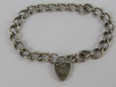 A HM silver curb link chain charm bracel