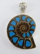 An unusual ammonite pendant set with tur