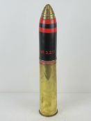 An inert WWI British 18pr shell, casing dated 1918, removable head and fuse. Standing 50cm high.