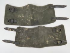 A pair of WWII German gaiters having leather straps.