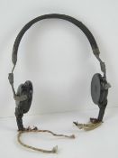A pair of WWII German / Russian headphones, wires cut, marked 4000 ohms.