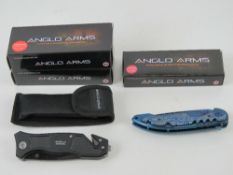 Three Anglo Arms pocket knives in original packaging.