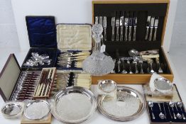 A large quantity of assorted silver plated and other cutlery including part set in wooden canteen,