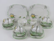 A 1920s Roslyn China tea service in Lily pattern comprising two sandwich plates, eight trios,