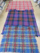 A woollen tartan throw ' The Clan Rug' bearing label upon and measuring 156 x 140cm.
