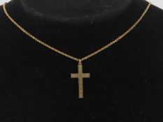 A 9ct gold crucifix having engine turned engraving upon, stamped 9ct,