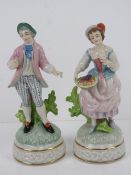 A pair of Continental Dresden type street seller figurines, each standing 19cm high,