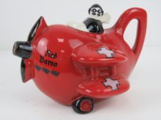 A contemporary Carltonware 'Red Barron' teapot and lid in the form of a biplane.