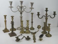 A quantity of assorted brass candlesticks together with one wall mounted twin candle sconce,