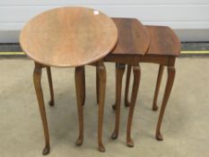 A nest of three 20th century walnut tables raised over slender taping legs, 60,