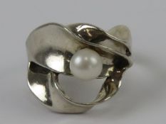 An abstract design silver and pearl ring, stamped 925 Israel, size O-P.
