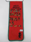 A 'Golly' brooch collection being twenty enamelled brooches on a felt sash, 54cm high.