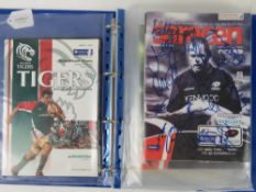 An album containing a quantity of signed Rugby programmes inc Tigers, Saracens, Saints, Wasps, etc.