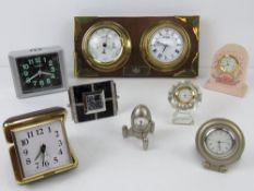 A brass clock and barometer set on wall hanging wooden mount having brass corner bracing, 24cm wide.