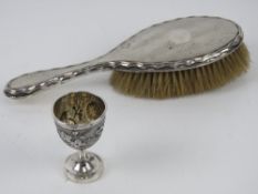 An Oriental Export silver egg cup having bird and foliate design upon,
