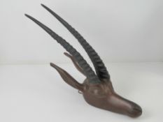 A carved wooden African gazelle head having ebonised antlers, approx 42cm in length.