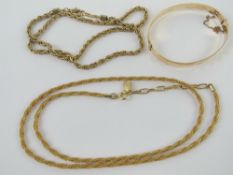 A 9ct gold metal core bangle together with two costume jewellery necklaces.