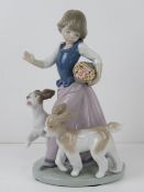 Lladro figurine 5761 'Out For A Romp' a girl with two dogs and a basket of flowers under her arm,