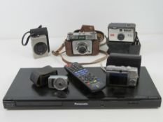 Camera equipment; a Yashica Yem35 Super light meter, a Kodak Instamatic 50, two Canon cameras,