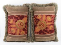 A pair of tapestry and green velvet throw cushions.