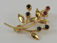 A delightful contemporary 9ct gold brooch of floral form set with sapphires and rubies,