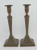 A good stepped pair of brass Georgian style candlesticks raised over stepped base, 26cm high.