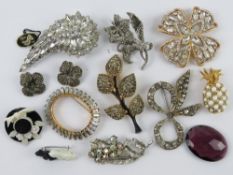 A quantity of assorted 20th century costume brooches including marcasite set flower,