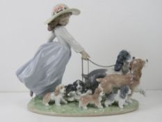 Lladro figurine 6784 'Puppy Parade' girl holding the chain leashes on brown and grey dogs with six
