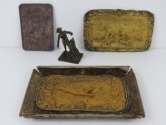 A pressed and gilded metal plate bearing two hares with foliate border, on a/f cardboard tray,