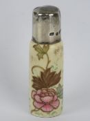 A hand painted ceramic perfume bottle having HM silver lid, 7.5cm high.