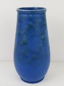 A matt blue pottery vase marked Barnstaple to base and numbered 394, standing 23.5cm high.