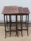 A good Edwardian nest of three mahogany tables each crossbanded with walnut and raised over slender