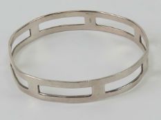 A hallmarked silver bangle having rectangular cut out design, slightly a/f, hallmarked 925,