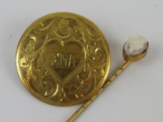 A circular yellow metal brooch having engraved floral decoration, pin a/f,