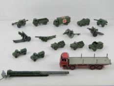 A quantity of Dinky toys and Britains army vehicles and artillery in play-worn condition.