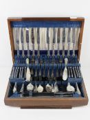 A large wooden canteen of silver plated cutlery for twelve sittings including carving set,