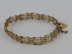 A 9ct gold 4-bar bracelet having heart padlock clasp,