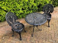 A cafe patio set comprising twin painted aluminium Victorian style chairs and matching circular