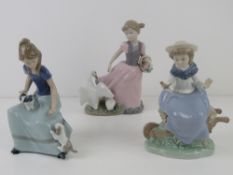 Two Nao LLadro figurines, girl on wheelbarrow with bird in hand 18cm high,