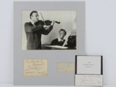 Autographs of Yehudi Menuhin and (Edward) Benjamin Britten mounted on board with photograph above,