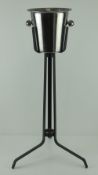 A champagne ice bucket on black painted metal stand, 77.5cm high.