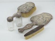A delightful Art Nouveau HM silver dressing table hand mirror and hairbrush,
