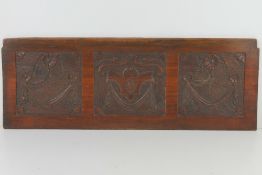 A carved mahogany panel having decorative swag designs in three sections, 67.8 x 24.3cm.