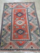 A teal and orange ground woollen rug having geometric design upon and measuring 185 x 130cm.