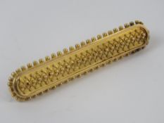 A yellow metal bar brooch, no apparent hallmarks, 4.8cm in length, 4g.