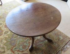 A circular occasional table raised over