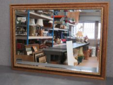 A contemporary gilt framed bevelled edge