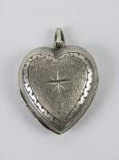 A silver locket in the form of a heart,